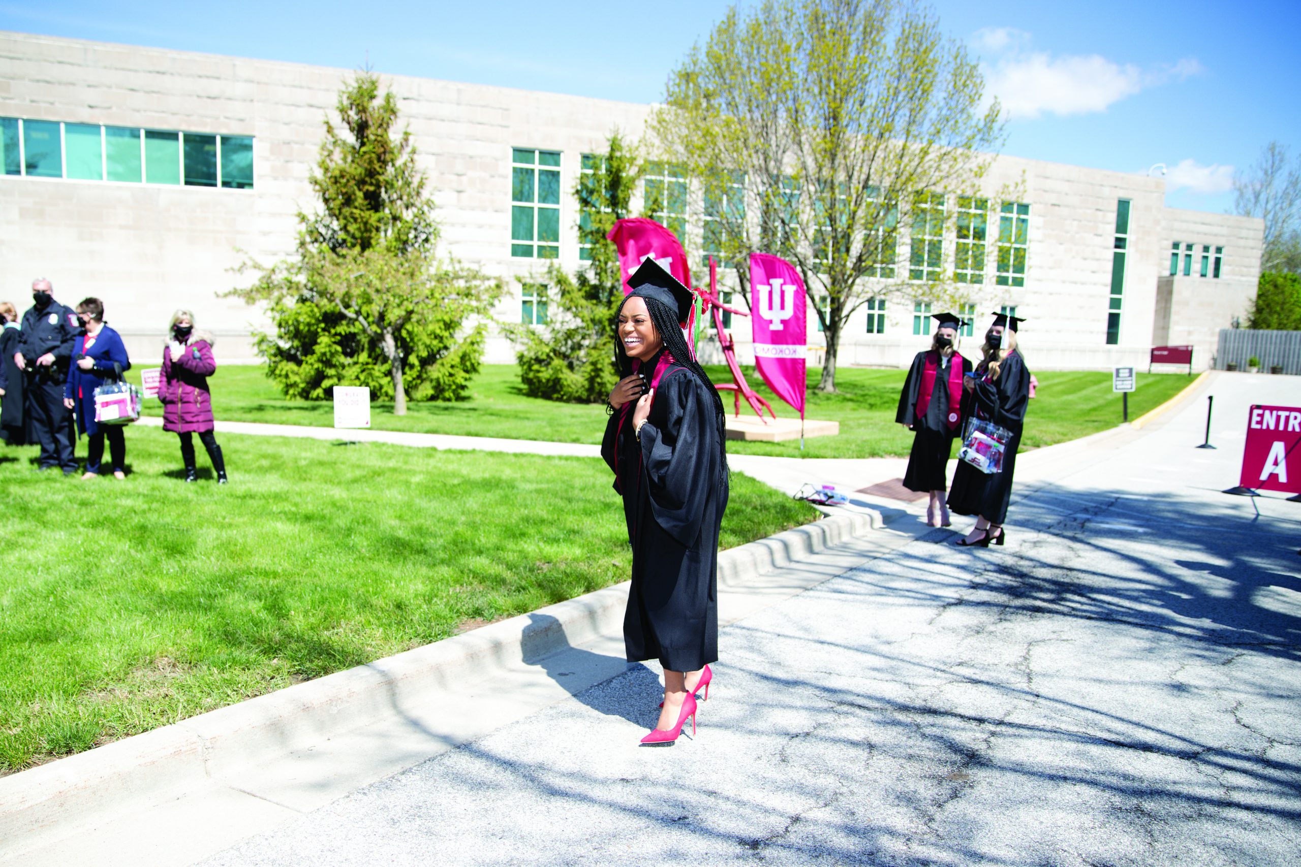 female graduate celebrating in cap and gown