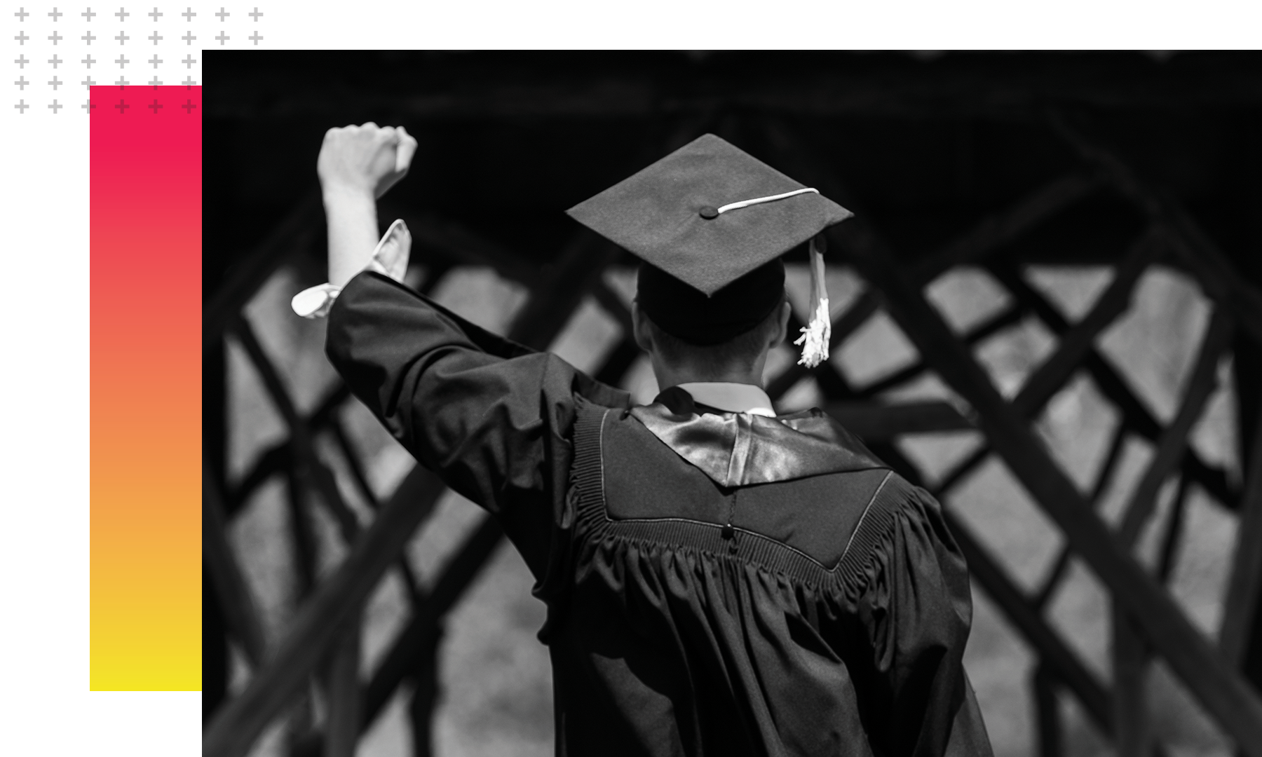 student with arm in the air walking away from the camera in a graduation cap and gown