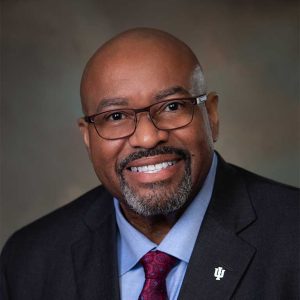 Black man in a suit, smiling