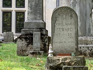 Photo of a gravestone reading, "Home at last. Doris Marie Seward, 1919-1999: She was an optimist. I.U. Class of 1938." (The first two digits of the death year were originally 20, but have been crossed out and replaced with 1999.)