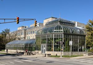Street view of a large glass greenhouse.