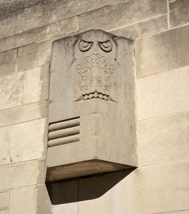 Photo of a stone owl carved into a building.