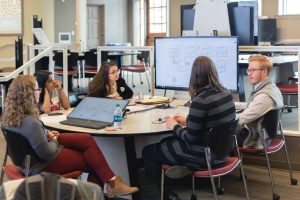 Students collaborate at a workspace in a Mosaic classroom.