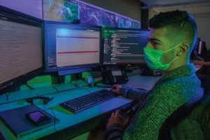 A GlobalNOC service desk technician works at his workstation