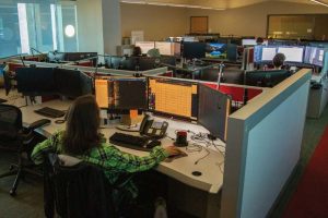 A GlobalNOC service desk technician works in his cubicle.