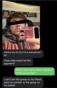 Male college student with blindfold to hide identity holds up another student's id.