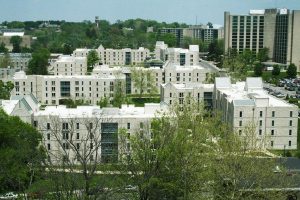 Several apartment buildings on a college campus.