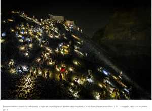 Miners searching for jade stones at night with torchlights in Kachin State, Myanmar