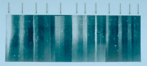 Photo showing a portion of an ice core from Greenland with arrows indicating light bands, which correspond to annual summer snows.