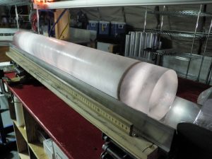 Photo showing one-meter long section of ice core with a dark ash layer.
