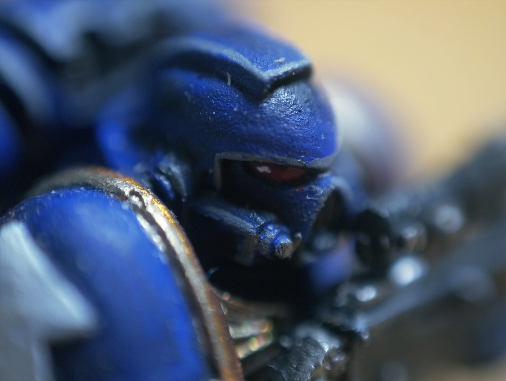 Close up of an Ultramarine mini. Man in a full suit of blue power armor.