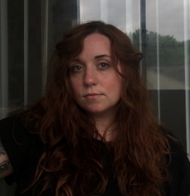 Image of the author. White woman with long curly hair.