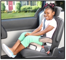 Child sitting in a backless booster seat