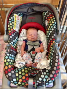 Infant with rolled receiving blankets for support