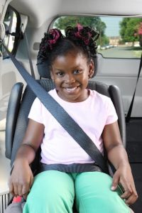 Child sitting in a booster seat