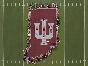 Members of the Indiana University Orientation Team pose on the field after Traditions and Spirit of IU in Memorial Stadium at IU Bloomington.