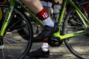 An IU rider wears socks adorned with the IU trident before the start of a bike race.