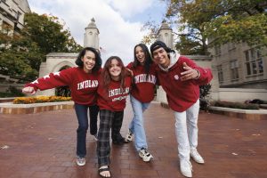 Indiana University fans posing in front of Sample Gates.