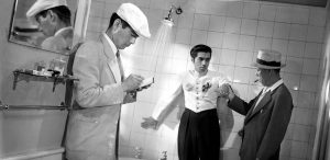 Another scene from Stray Dog, Sato and Murakami interrogate a small time gangster in a hotel bathroom