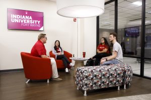 Student and staff discussion takes place at Indiana University Fort Wayne Student Central Office in Neff Hall.
