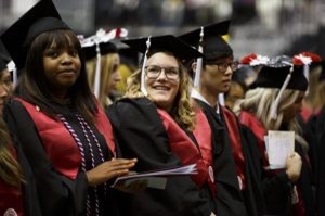 A graduate smiles during the conferral of degrees at the IU Northwest Commencement at the Genesis Convention Center.