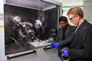 IU Indianapolis professor and students examine a robot in Innovation Hall.