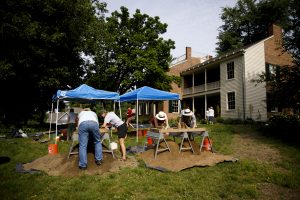 Students work with researchers from the Glenn A. Black Laboratory of Archaeology on the front lawn of Wylie House in Bloomington.