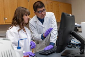 Student and instructor reviewing results in a lab at IU East.