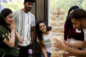 Students react to a game of Jenga in Wells Library.