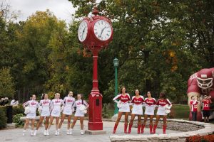 Indiana University cheerleaders and RedSteppers sway during the playing of the alma mater at a pep rally near Woodburn Hall at IU Bloomington.