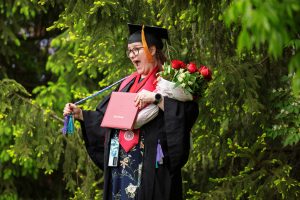 A graduate poses for a photo during the IU Kokomo Commencement.