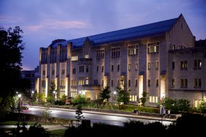 Hodge Hall at the Indiana University Kelly School of Business is illuminated on a summer evening at IU Bloomington.