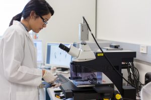 Female Science student at IU using lab equipment