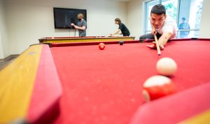 Student playing pool at IU South Bend.