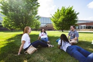 Students relaxing outside on a sunny day at IU Columbus.