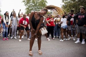 A student tosses their hair as they dance in the middle of a dance circle during CultureFest on the Fine Arts Plaza at IU Bloomington.