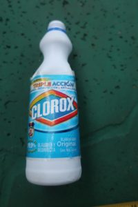 Object 3: Close up of the label on the white plastic Clorox bottle about 8.5 inches tall. Clorox label still present, writing is visible, discernable, and in Spanish