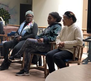 Three women seated in chairs