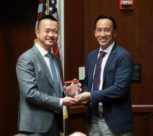 Faculty member presenting award trainee