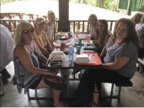 A photo of a group of people posing at a table.