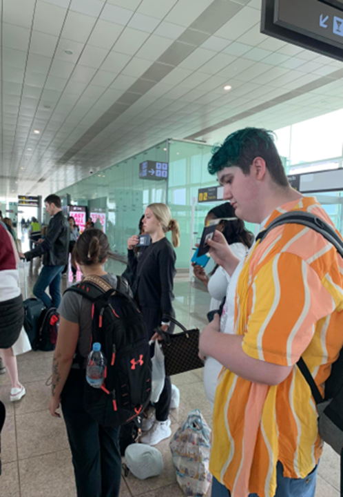 A group of people waiting in a airport.