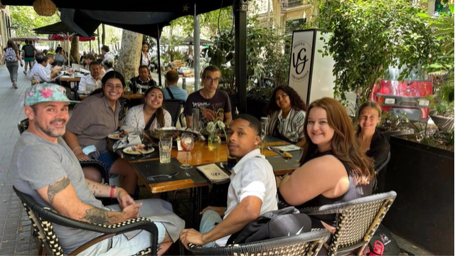 A photo of a group of people posing at a table.