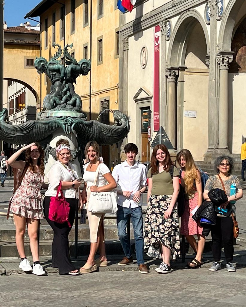 Image of a group of people posing in front of a fountain.