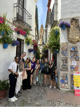 A photo of a group of people posing in a street.