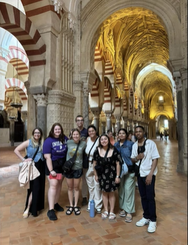 A photo of a group of people posing in a building.