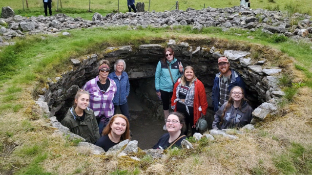 A photo of a group of people standing in ancient Scottish ruins.