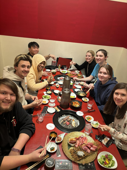 Image of a group of people sitting at a table.