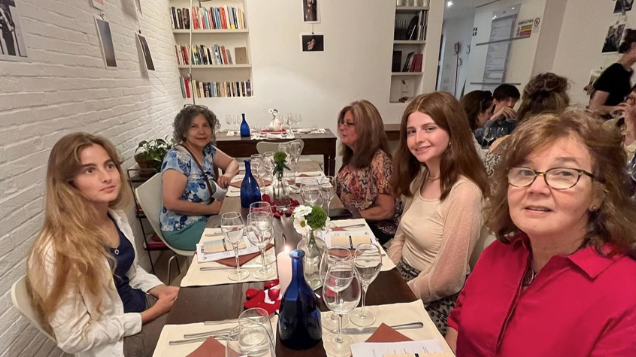 A photo of five people sitting at a table.