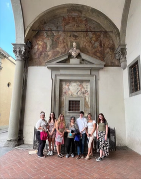 A photo of people standing in front of a building.