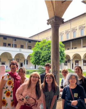 A photo of a group of people posing in an outdoor garden.